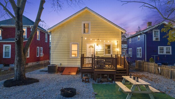 A wooden house with a porch, a small deck, and a gravel yard. - Modern 4 Bedroom Beach House: Ideal for Families & Long Stays (West Haven)