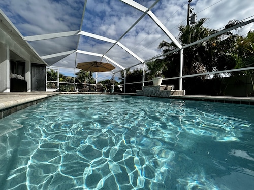 Tropical Oasis sleeps 13 with a heated pool.  Free WiFi.  Close to everything   