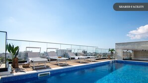 A rooftop pool with lounge chairs and a view of the city. - Sanders Crystal 1 - Large 4-bdr Penthouse With Shared Pool (Limassol)