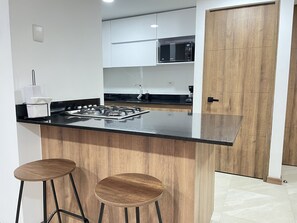 Apartment | Private kitchen | Full-sized fridge, microwave, stovetop, espresso maker - HOUSINN co-living Fátima (Medellín)