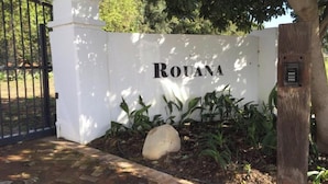 A white wall with the word "ROUANA" in black letters. - Rouana Guest Farm (Stellenbosch)