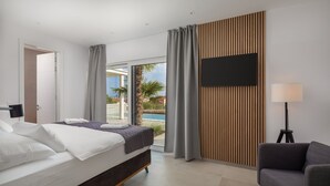 A modern hotel room with a bed, a desk, a chair, and a TV. - Luxury Villa Superstar with Pool (Vodice)