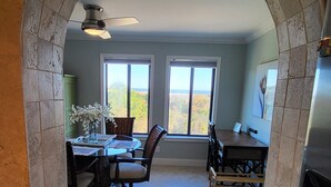 A spacious kitchen with an archway, large windows, and a view of the outdoors. - RENOVATED LUXURY BEACH VILLA,Ocean view,3 bdrms each with smart tv and king bed (Hilton Head Island)