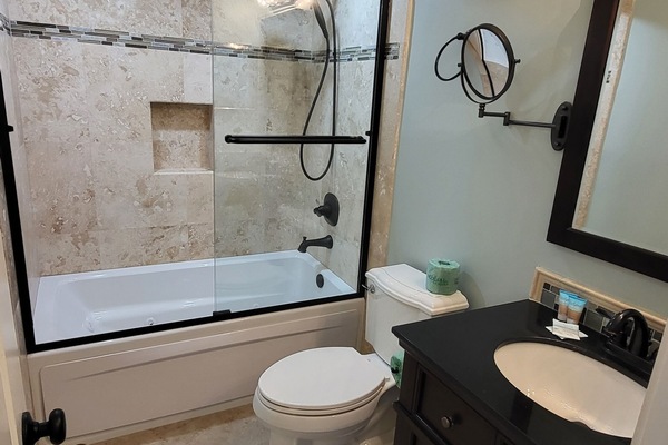 Primary bedroom has a private bath with tub and shower