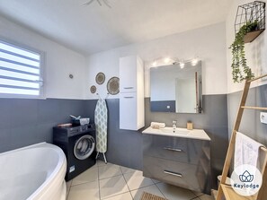 Bathtub, hair dryer, towels, soap