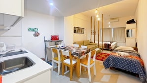 A compact hotel room with a kitchenette, a dining area, a bed with a canopy, and a small bathroom. - San Telmo - Paseo De La Cisterna Building (Buenos Aires)