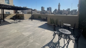 A rooftop terrace with outdoor seating, a pergola, and a city skyline view. - San Telmo - Paseo De La Cisterna Building (Buenos Aires)