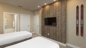 A bedroom with two beds, a TV mounted on a wooden wall, and skis on the wall. - Welcome Home! 4Beds/4.5 Baths, Entire House near Disney, Free Parking & Wi-Fi, (Kissimmee)