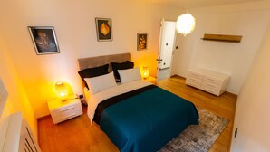 A bedroom with a bed, bedside tables, a nightstand, a dresser, and wall-mounted artwork. - *Free parking* Chic and elegant in VILLEURBANNE *All-inclusive* (Villeurbanne)