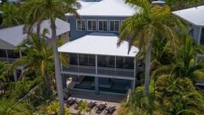 A two-story house with a balcony and a pool. - Getaway By The Bay-4 bedrooms-Large private pool and spa across from the bay!! (Bradenton Beach)