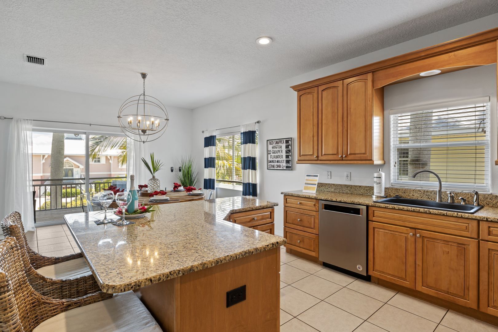 A modern kitchen with granite countertops, wooden cabinets, and a built-in dishwasher.