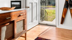 A room with a wooden cabinet, a door leading outside, and skis leaning against the wall. - Tims Ford Lake, Sewanee, and Historic Downtown Winchester (Winchester)