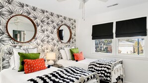 A bedroom with two beds, a large mirror, a ceiling fan, and a window with black blinds. - Tims Ford Lake, Sewanee, and Historic Downtown Winchester (Winchester)
