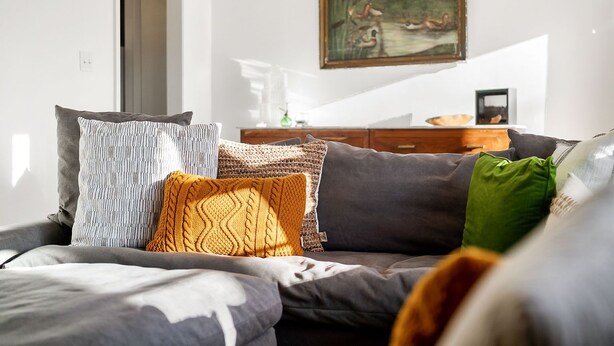 A modern living room with a sofa, a painting, and a wooden dresser. - Tims Ford Lake, Sewanee, and Historic Downtown Winchester (Winchester)