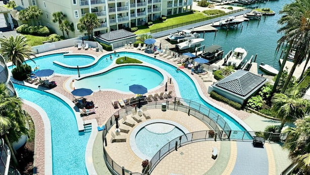 A resort with multiple swimming pools, a marina, and a large building with balconies. - Premiere Pet Friendly 2nd Floor Unit W/ Lazy River Indoor Pools & Gulf Views (Orange Beach)