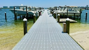 A pier leading to docked boats with a clear sky and water. - Premiere Pet Friendly 2nd Floor Unit W/ Lazy River Indoor Pools & Gulf Views (Orange Beach)