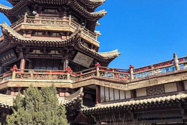A traditional multi-tiered pagoda-style building with balconies and railings. - Bowen Elegant Hotel (Dunhuang Night Market Shop) (Dunhuang)