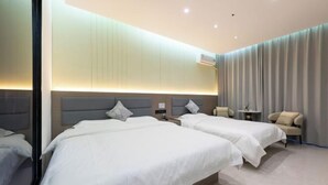 A modern hotel room with two beds, a small table, a chair, and a large window with curtains. - Bowen Elegant Hotel (Dunhuang Night Market Shop) (Dunhuang)