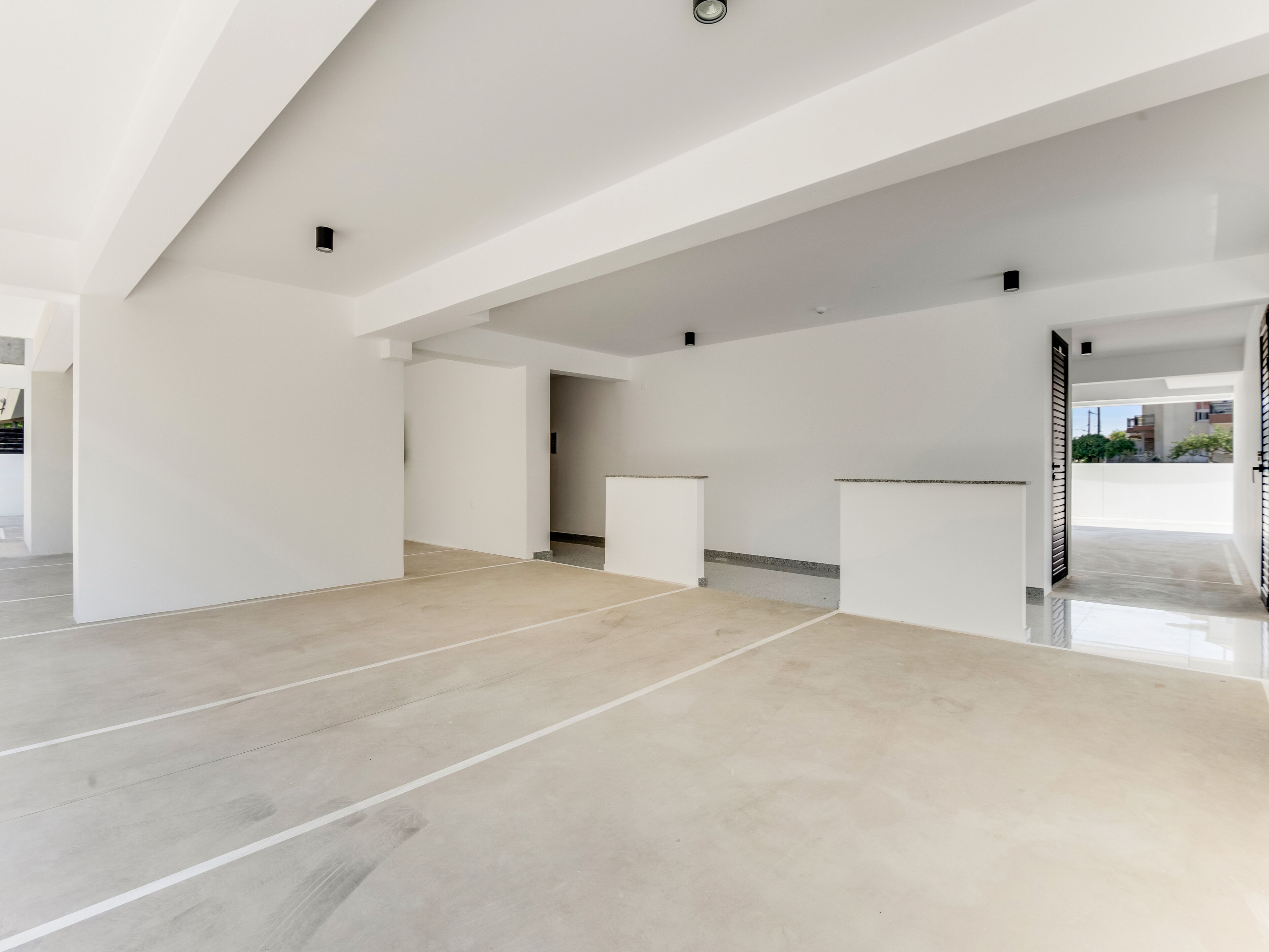 A spacious, modern interior with high ceilings and a minimalist design.