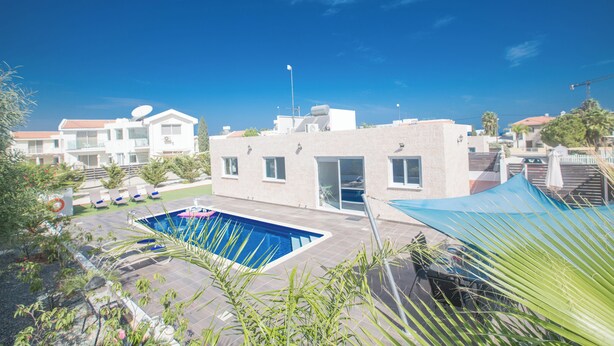 A residential building with a swimming pool, a covered patio, and a view of neighboring houses. - Protaras Holiday Villa Gd44 (Paralimni)