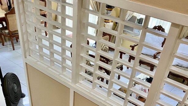 A wooden staircase with a white railing, leading to a room with a view of a balcony. - House w 3 Bedrooms And 3 Baths - Free Parking (Olongapo)