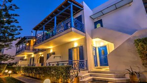 A two-story building with a balcony, a blue door, and a lighted entrance. - Bbq, Backyard, Of Amoudara, Full Kitchen, Parking-3 (Malevizi)