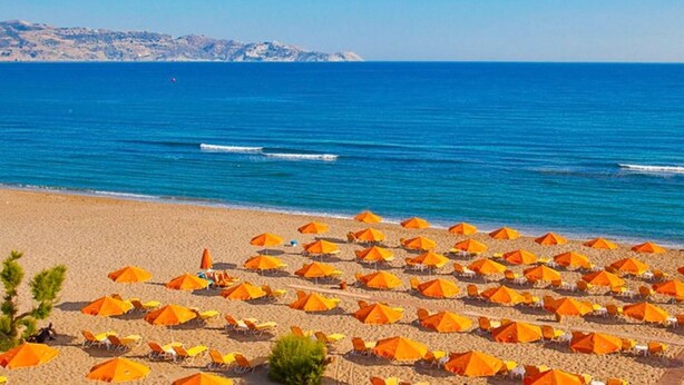 A beach with numerous orange umbrellas and a clear blue sea. - Bbq, Backyard, Of Amoudara, Full Kitchen, Parking-3 (Malevizi)