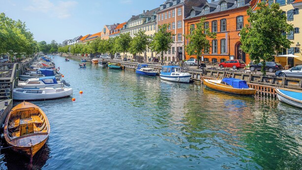 A canal lined with colorful buildings and boats docked along the water.