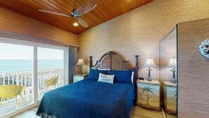 A bedroom with a large bed, wooden ceiling, and a view of the ocean. - Southern Jewel 1 Bedroom | 1.5 Baths | Sleeps 4 (Navarre Beach)