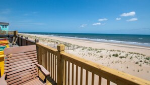 A wooden deck with a view of a beach and ocean. - Oceanfront, Guest House, Hot Tub & Spacious Decks (Avon)