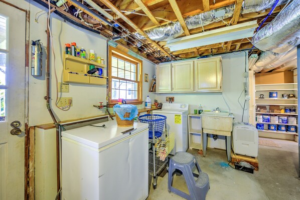 A compact kitchen with basic appliances, a window, and a wooden ceiling. - Sandy Toes & Sunset Views at Sagamore Beach (Sagamore Beach)