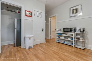 A kitchen with a refrigerator, microwave, coffee maker, and a coffee bar. - Oak Park, IL, entire house, short walk to train. (Oak Park)