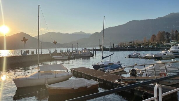 A marina with boats docked, a clear sky, and mountains in the background. - Holiday Apartment "Casa Tovini" with Mountain View, Terrace & Wi-Fi (pisogne)