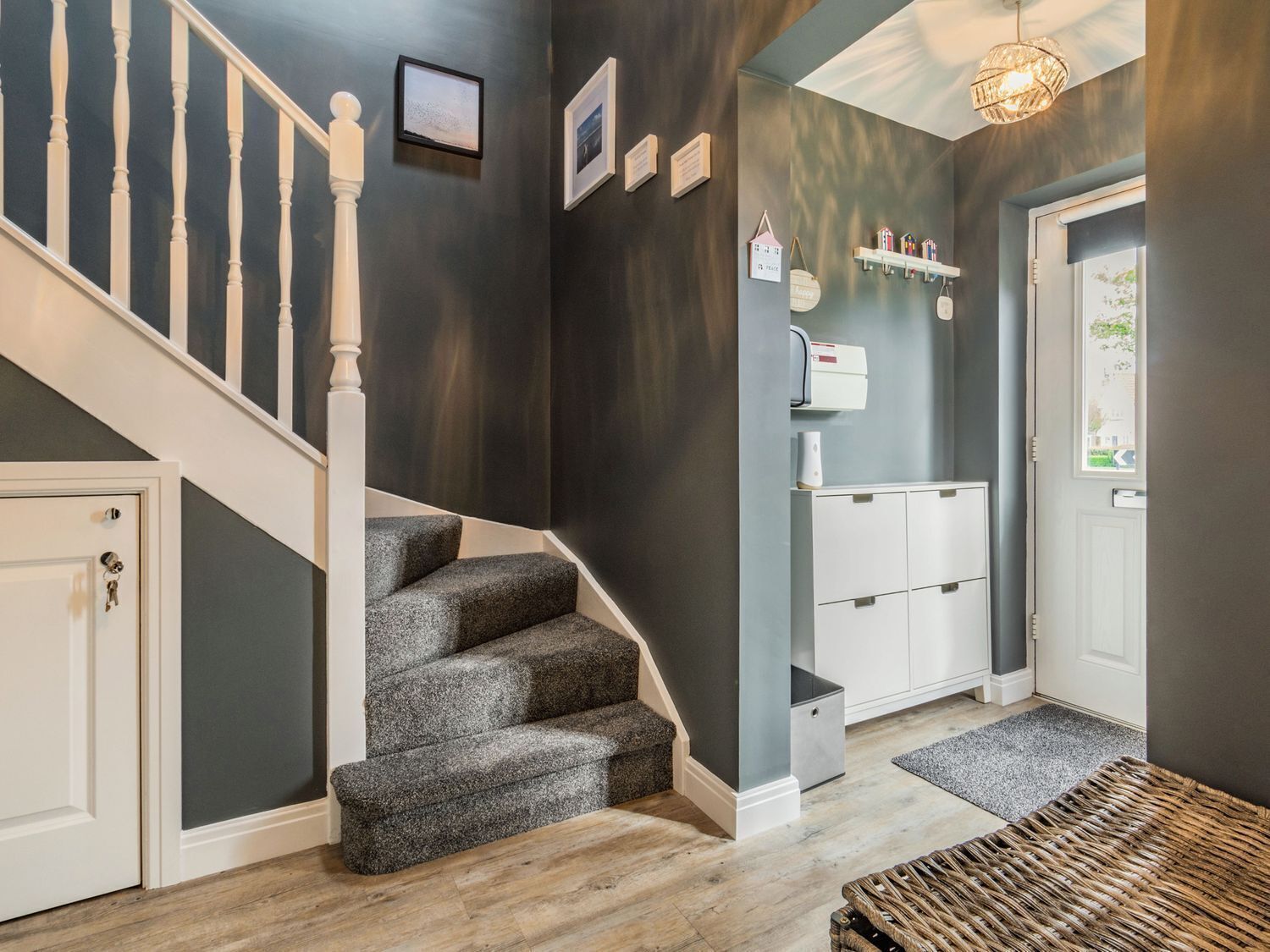 A staircase with a white railing leading to a landing.