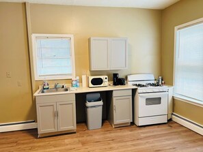 Fridge, microwave, coffee/tea maker, cookware/dishes/utensils