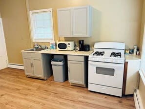 Fridge, microwave, coffee/tea maker, cookware/dishes/utensils