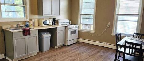 Fridge, microwave, coffee/tea maker, cookware/dishes/utensils