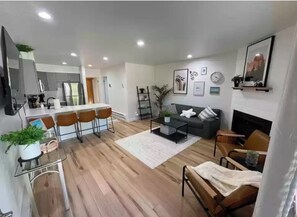 Relax in a warm and inviting space with a dining area, comfortable seating, and a cozy fireplace.