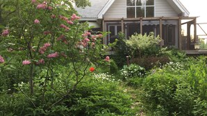A house with a large window and a porch. - Secluded cottage on Seguin river with sauna and screened in porch (Seguin)