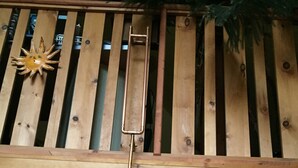 A kitchen with wooden cabinets, a microwave, and a hanging light fixture. - Secluded cottage on Seguin river with sauna and screened in porch (Seguin)