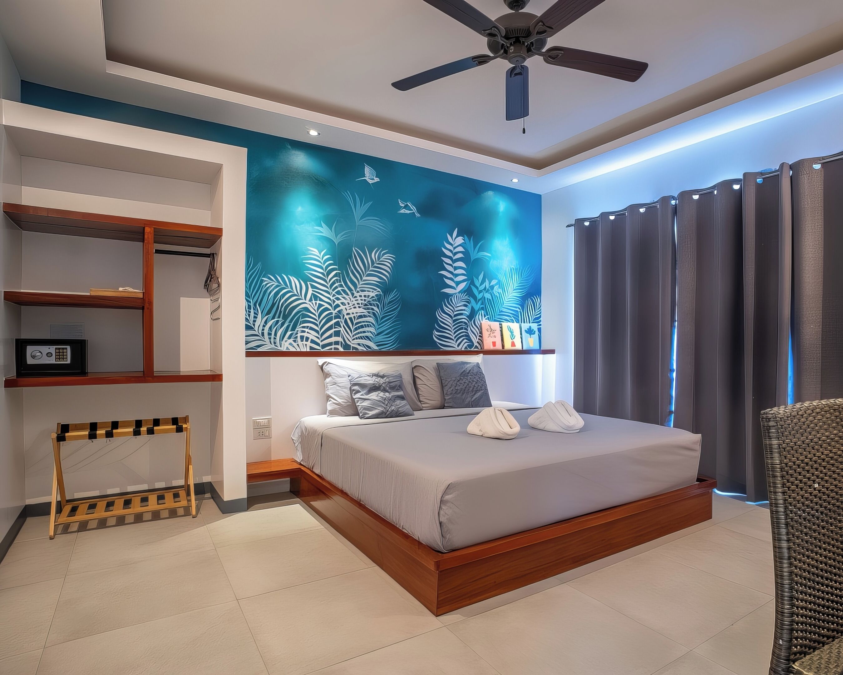 A modern bedroom with a bed, a ceiling fan, a wall-mounted shelf, and a large window with curtains.