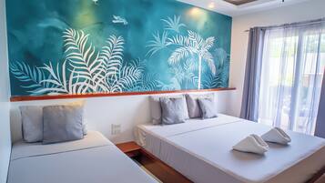A modern hotel room with two beds, a large wall mural, and a view of the outdoors.