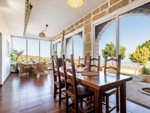 A dining area with a large table, chairs, and a view of the landscape. - Finca Los Blanquitos Amazing with 3,000 m2 of land (Granadilla de Abona)