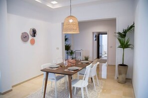 Enjoy meals in this stylish dining area with a table for four, pendant light, and decorative accents.