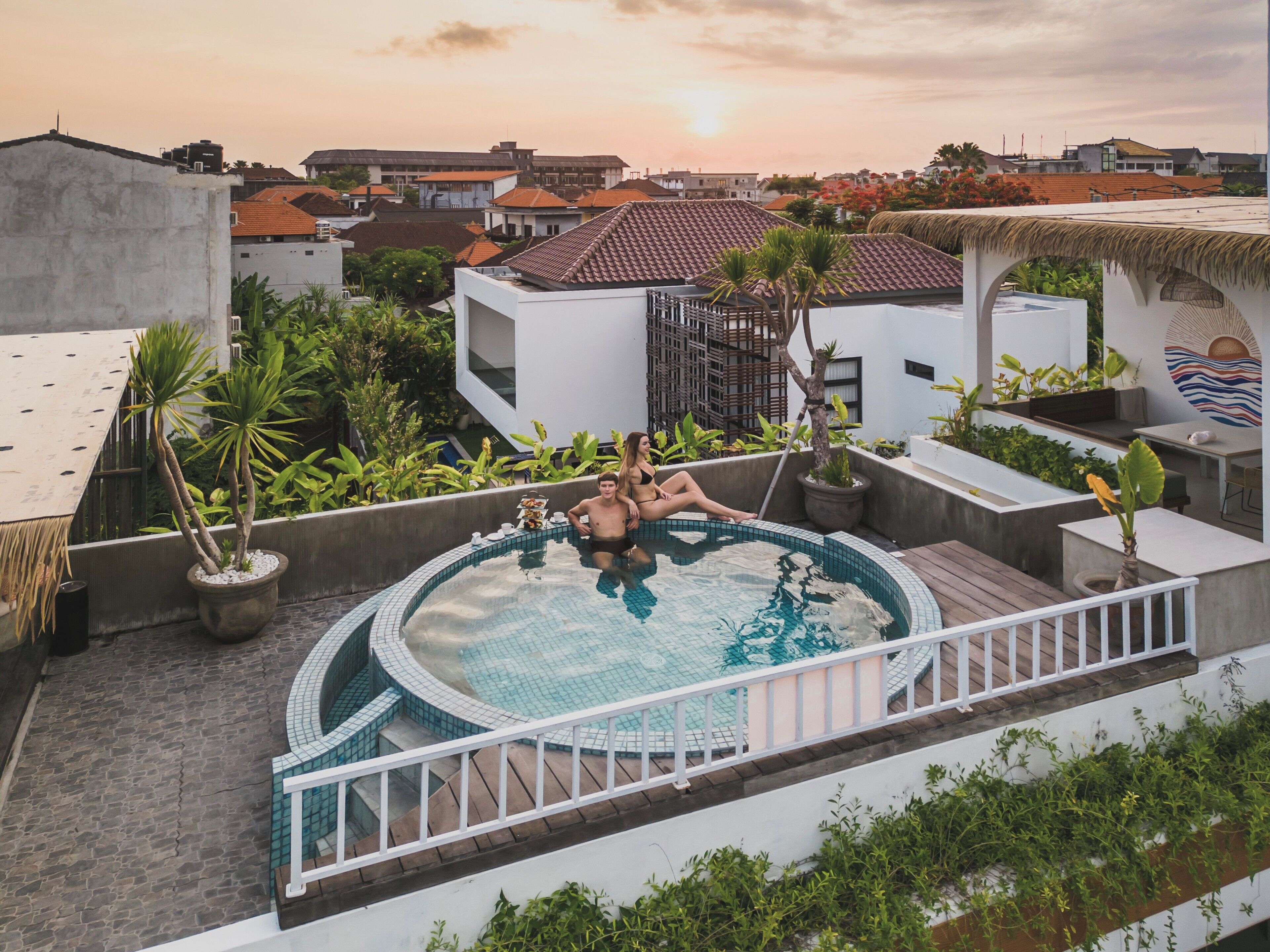 A rooftop swimming pool with a view of the cityscape.