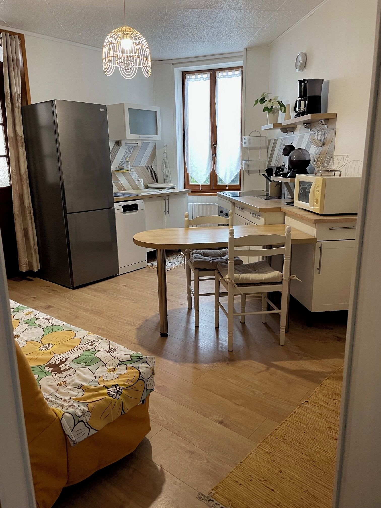 A compact kitchen with a refrigerator, microwave, and coffee maker.