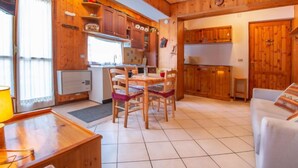 Ein gemütliches Blockhauss-Interieur mit Essbereich, Küche und Wohnbereich.