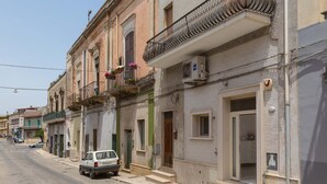 A row of multi-story buildings with balconies, a parked car, and a street. - 3063 Dimora Ilenia by Barbarhouse (Oria)