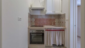 A compact kitchen with a built-in oven, a small countertop, and a cabinet above the sink. - 3063 Dimora Ilenia by Barbarhouse (Oria)