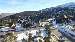 A snow-covered residential area with houses and a parking lot. - Arette: Large studio for 6 near slopes, parking, dishwasher (Arette)